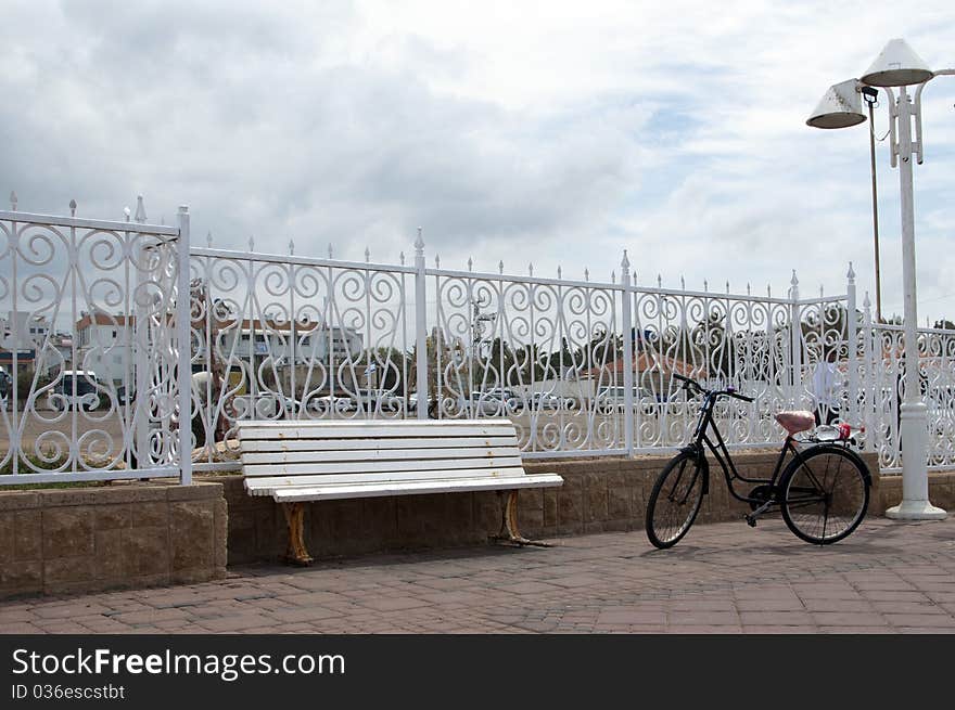 White bench and bike in the park