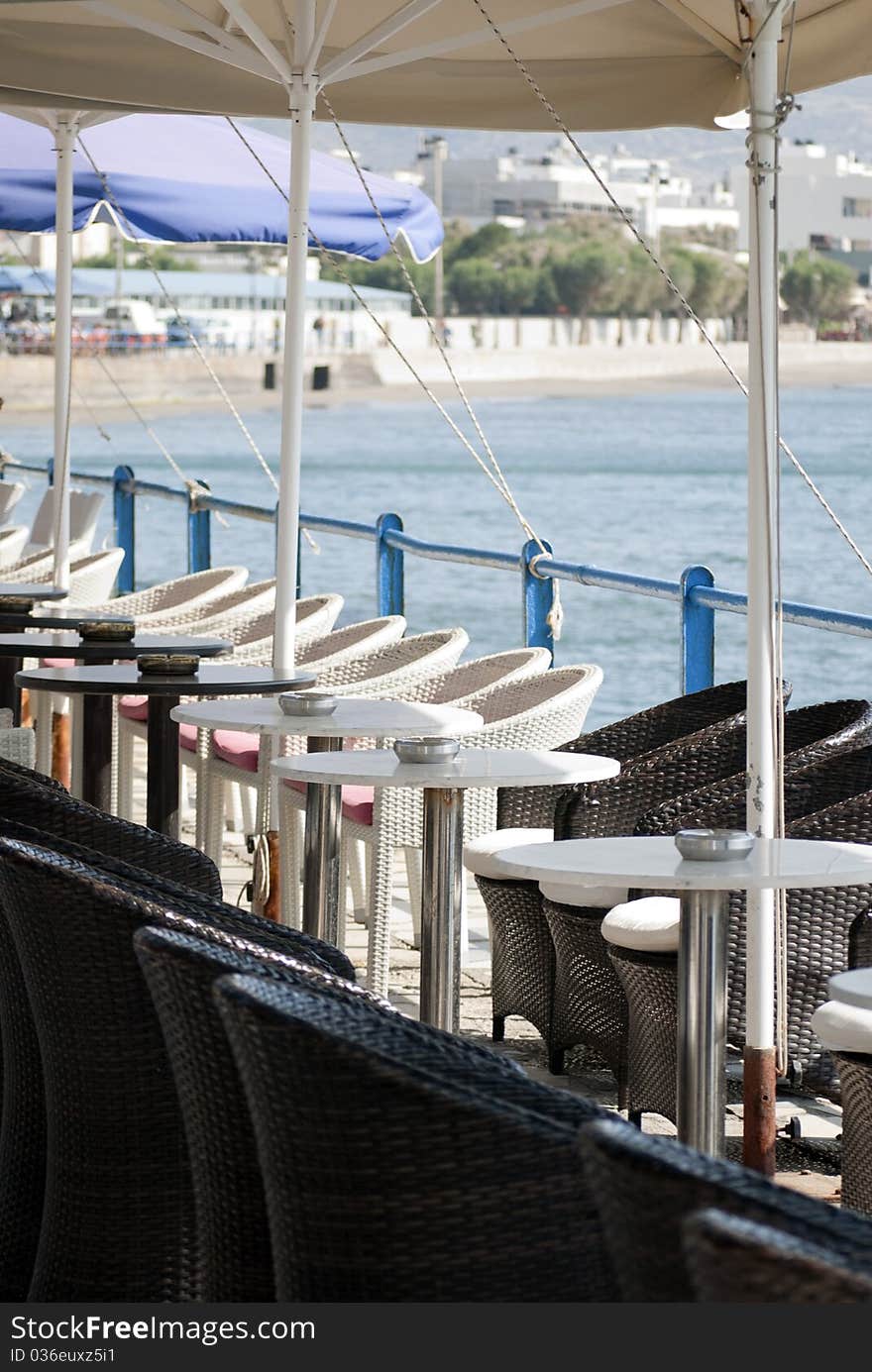 Tables and chairs on the background of the sea and mountains