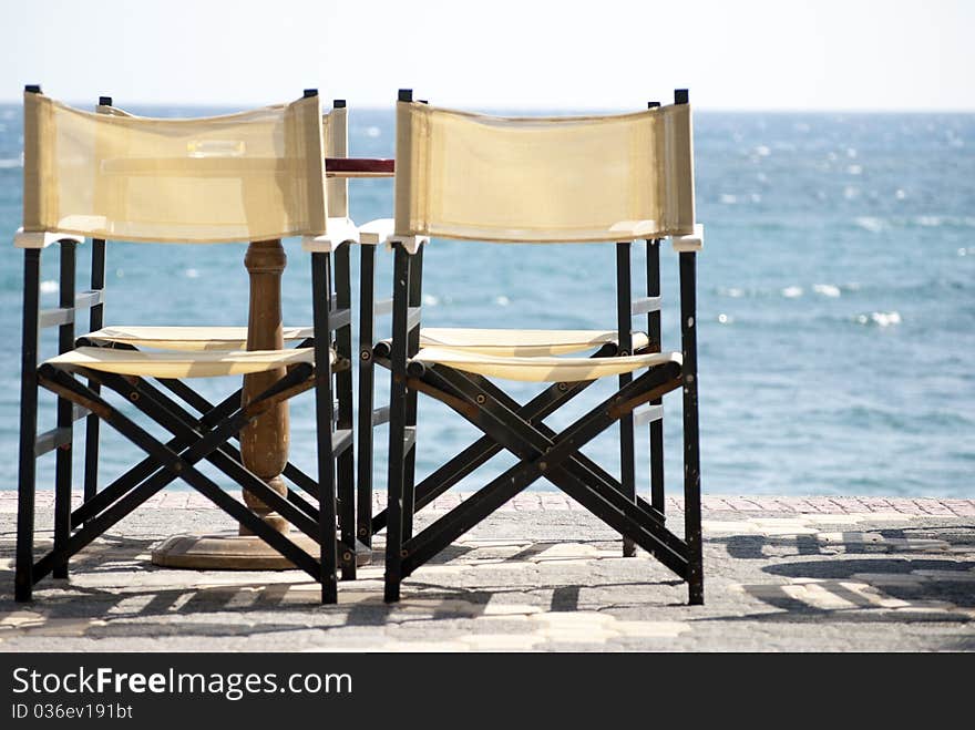 Tables and chairs on the background of the sea