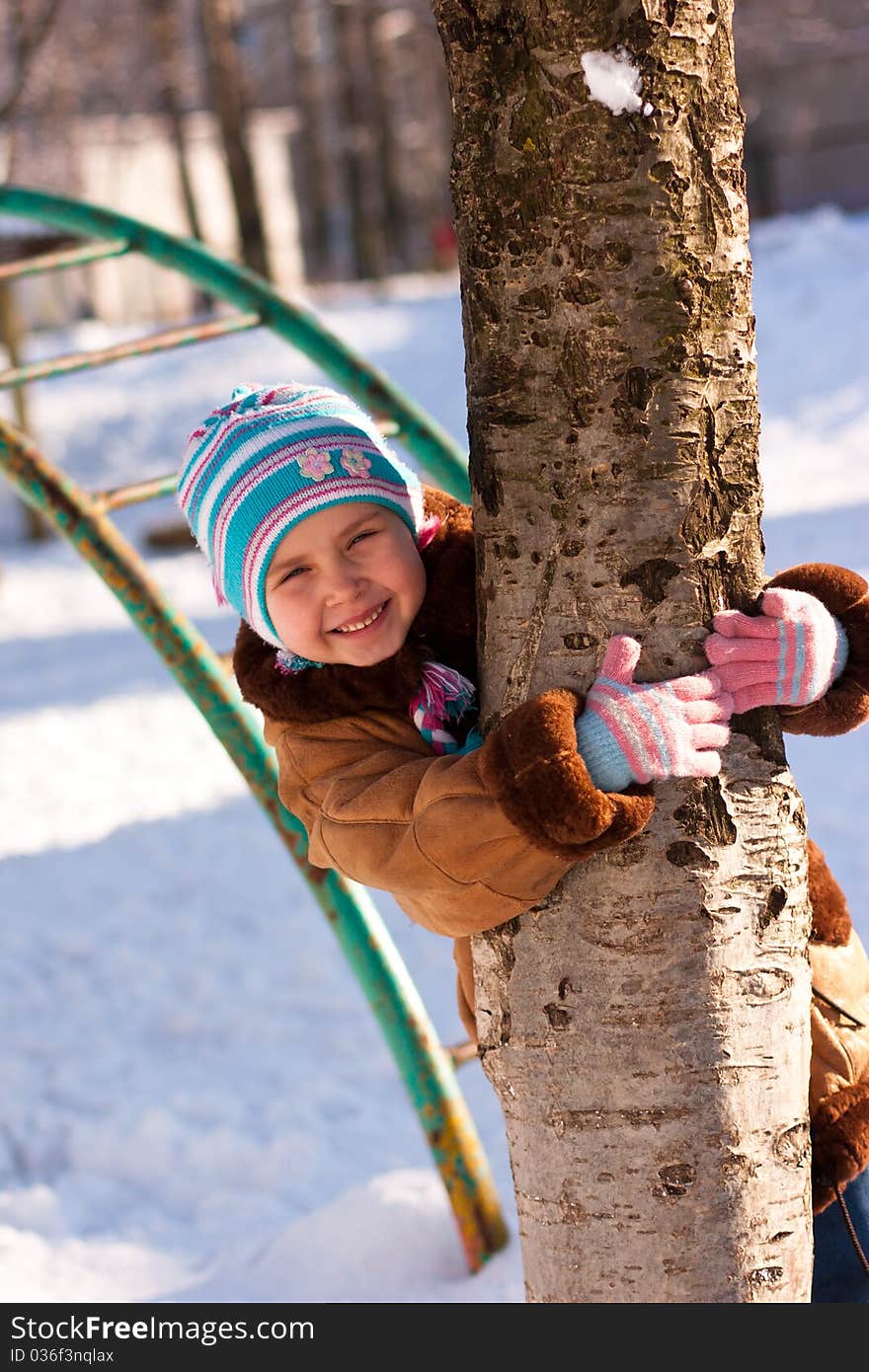 Beautiful Girl Hugging A Tree In Winter