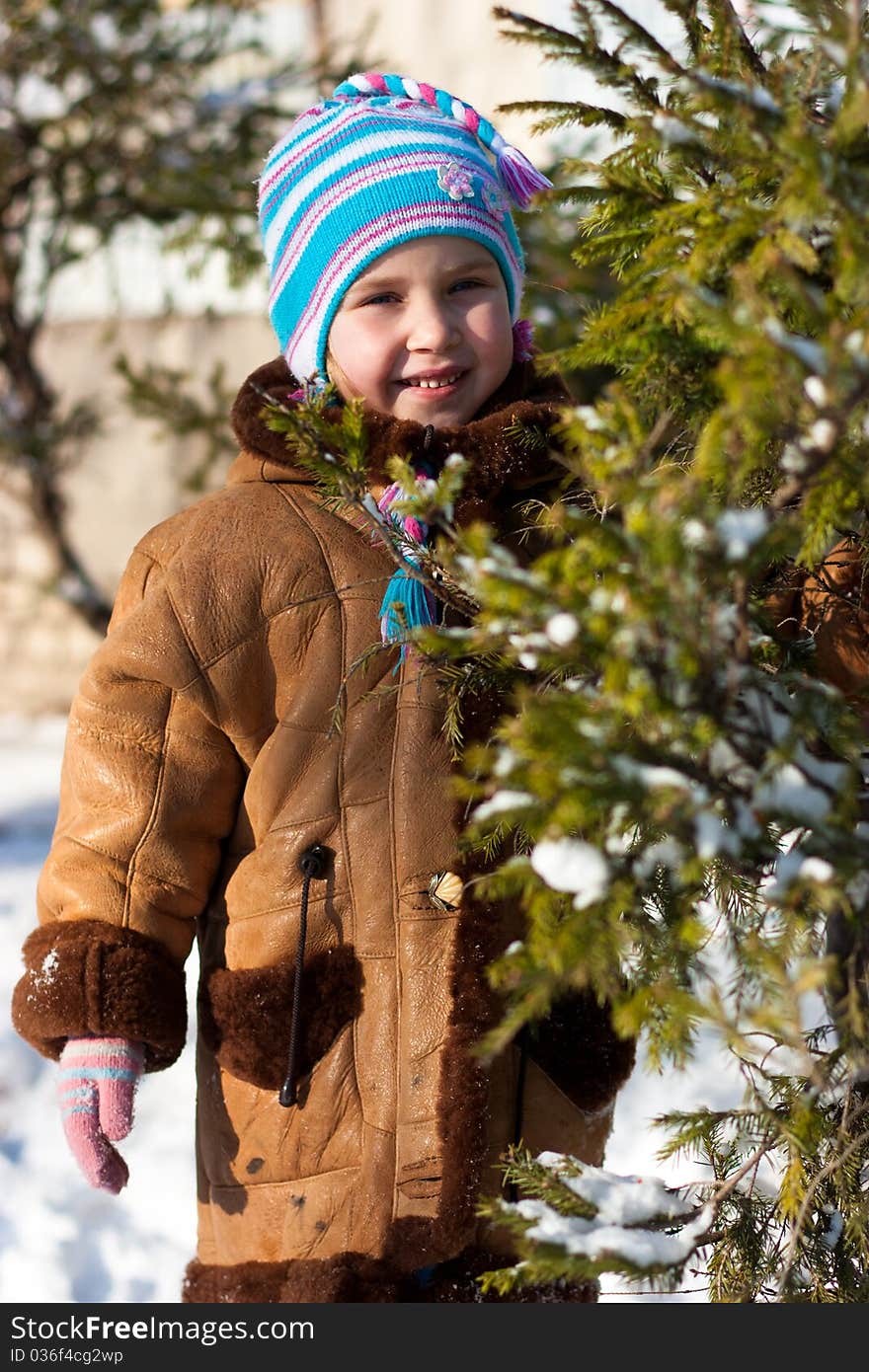 Beautiful girl near firtree outdoor in winter. Beautiful girl near firtree outdoor in winter