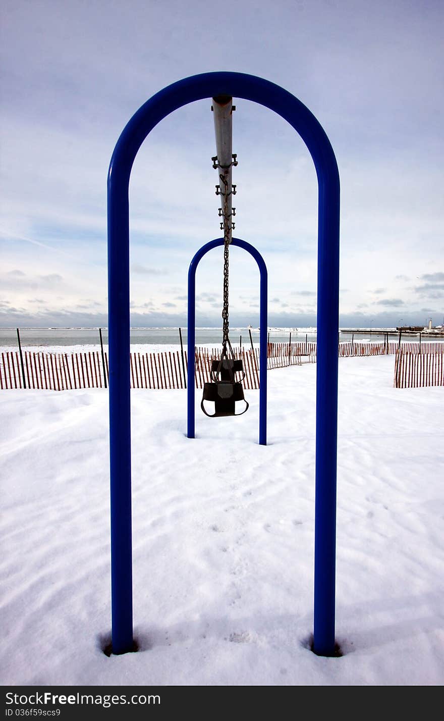 An empty playground by the lake in the winter