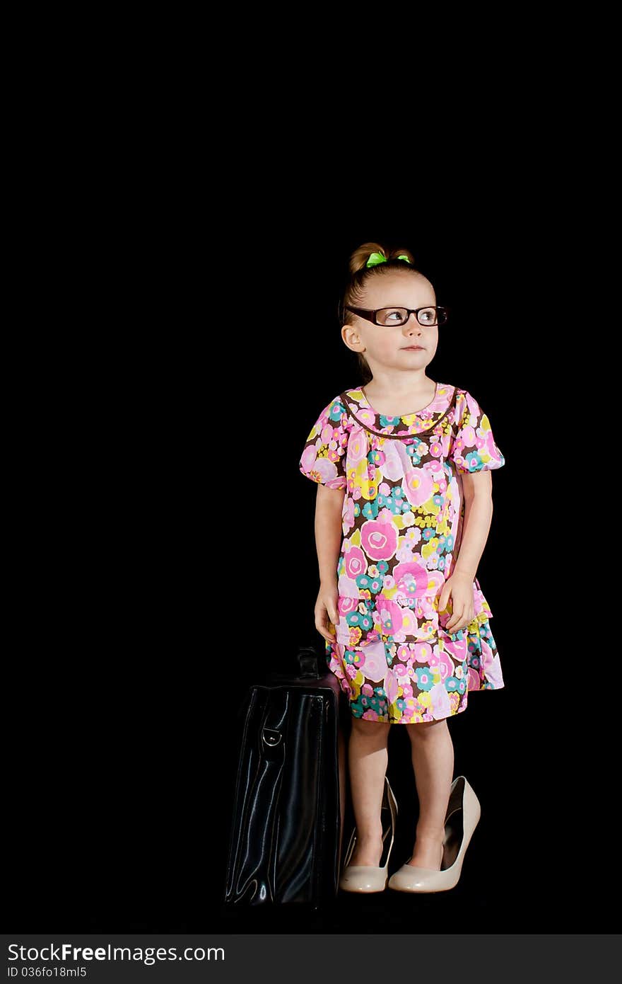 A cute little girl dressed up like an adult. She is wearing full sized shoes, adult glasses and has a briefcase to add to the cuteness factor!. A cute little girl dressed up like an adult. She is wearing full sized shoes, adult glasses and has a briefcase to add to the cuteness factor!