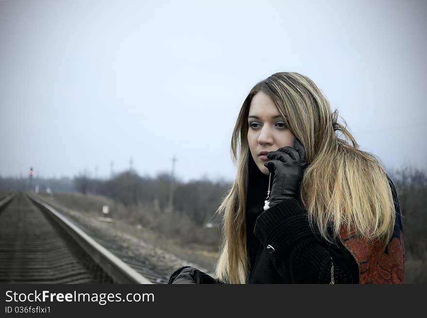 The confused beautiful girl speaks by phone. The confused beautiful girl speaks by phone