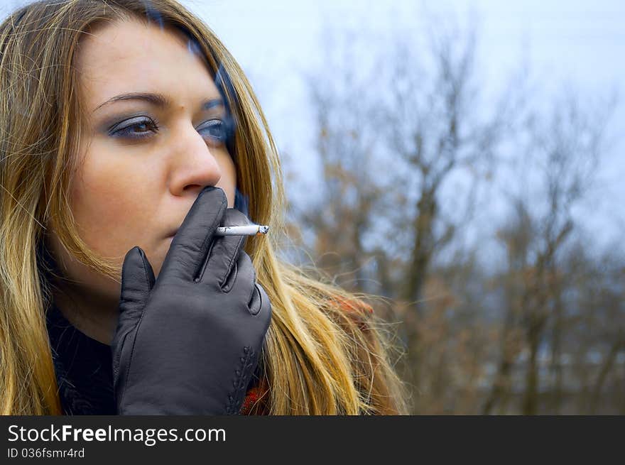 The beautiful girl smokes