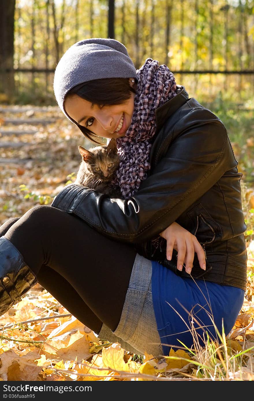 Young girl with a kitty outdoors