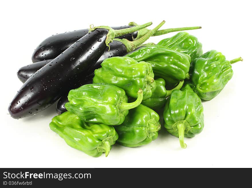 Green peppers and purple eggplant on white background