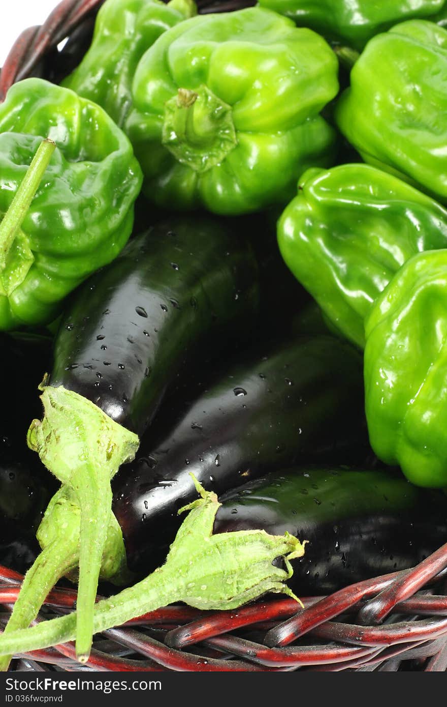 Green peppers and purple eggplant on white background