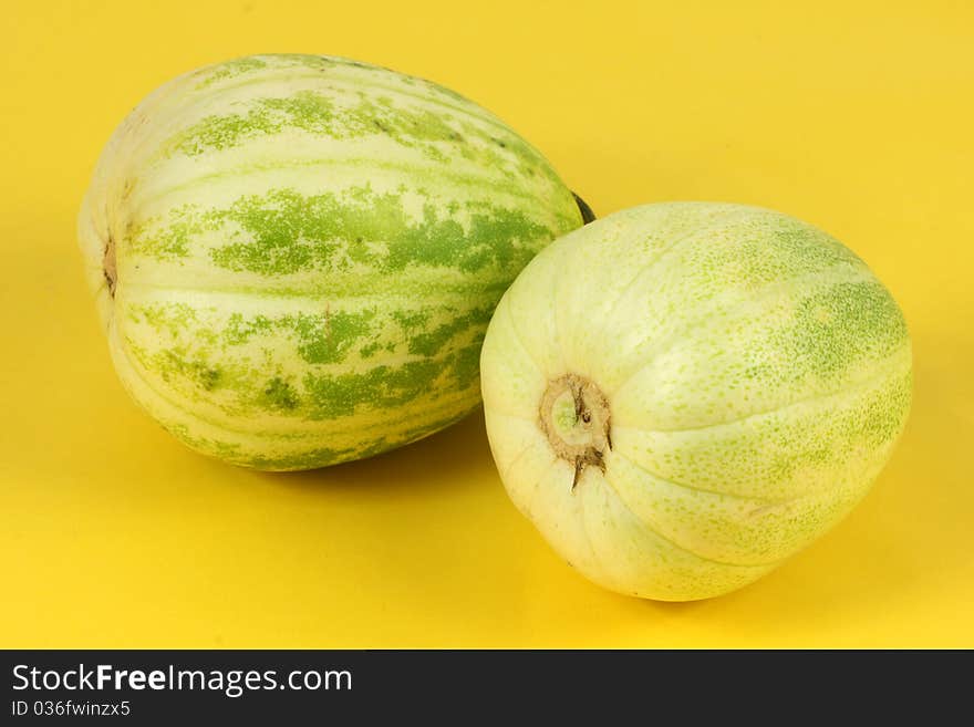 Two melon on yellow background