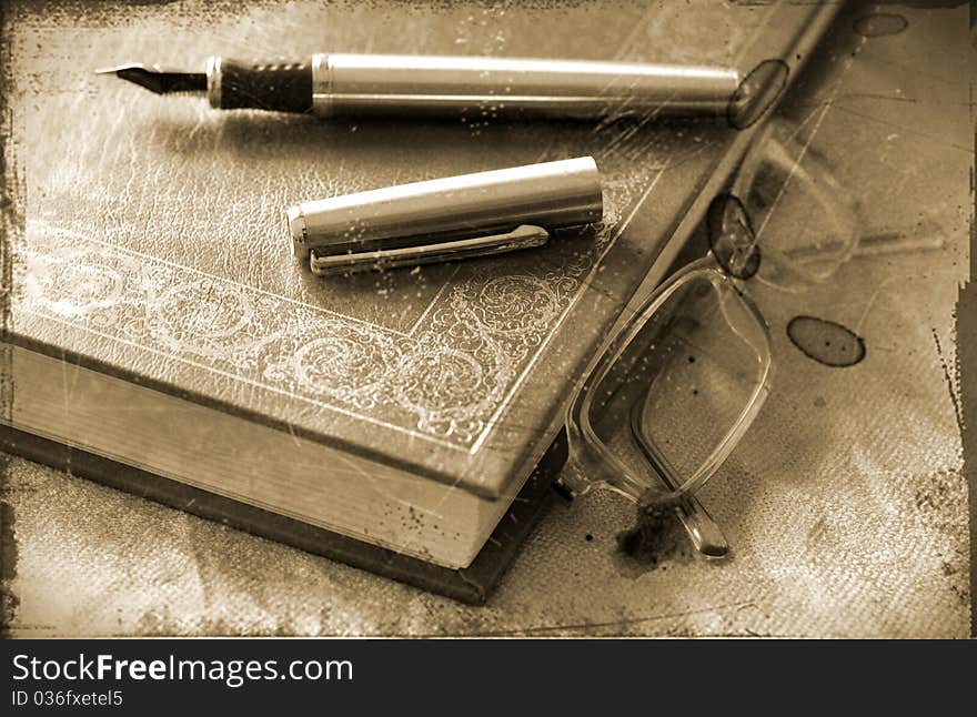 Pen, glasses and book aged picture. Pen, glasses and book aged picture