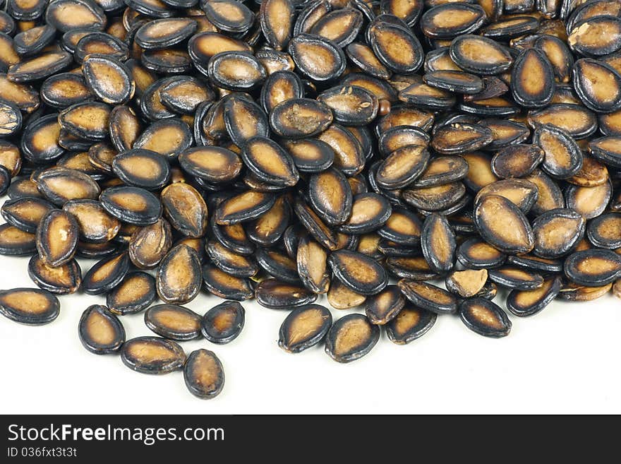 Black melon seeds on white