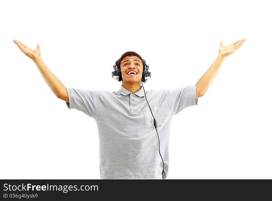 Young happy man listening to music and singing