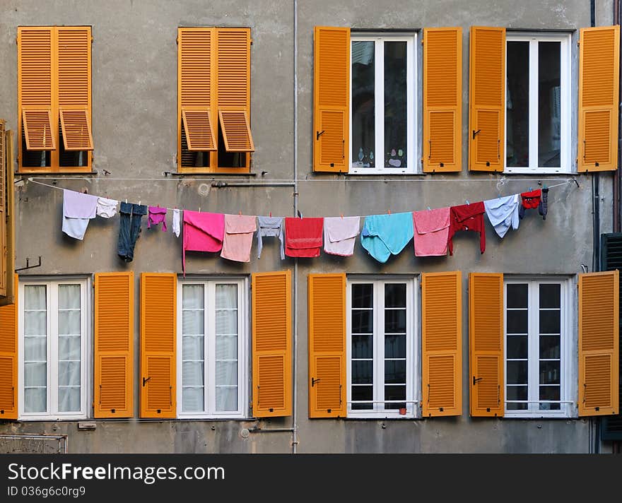 Windows with clothes hanging in the streets of Genoa