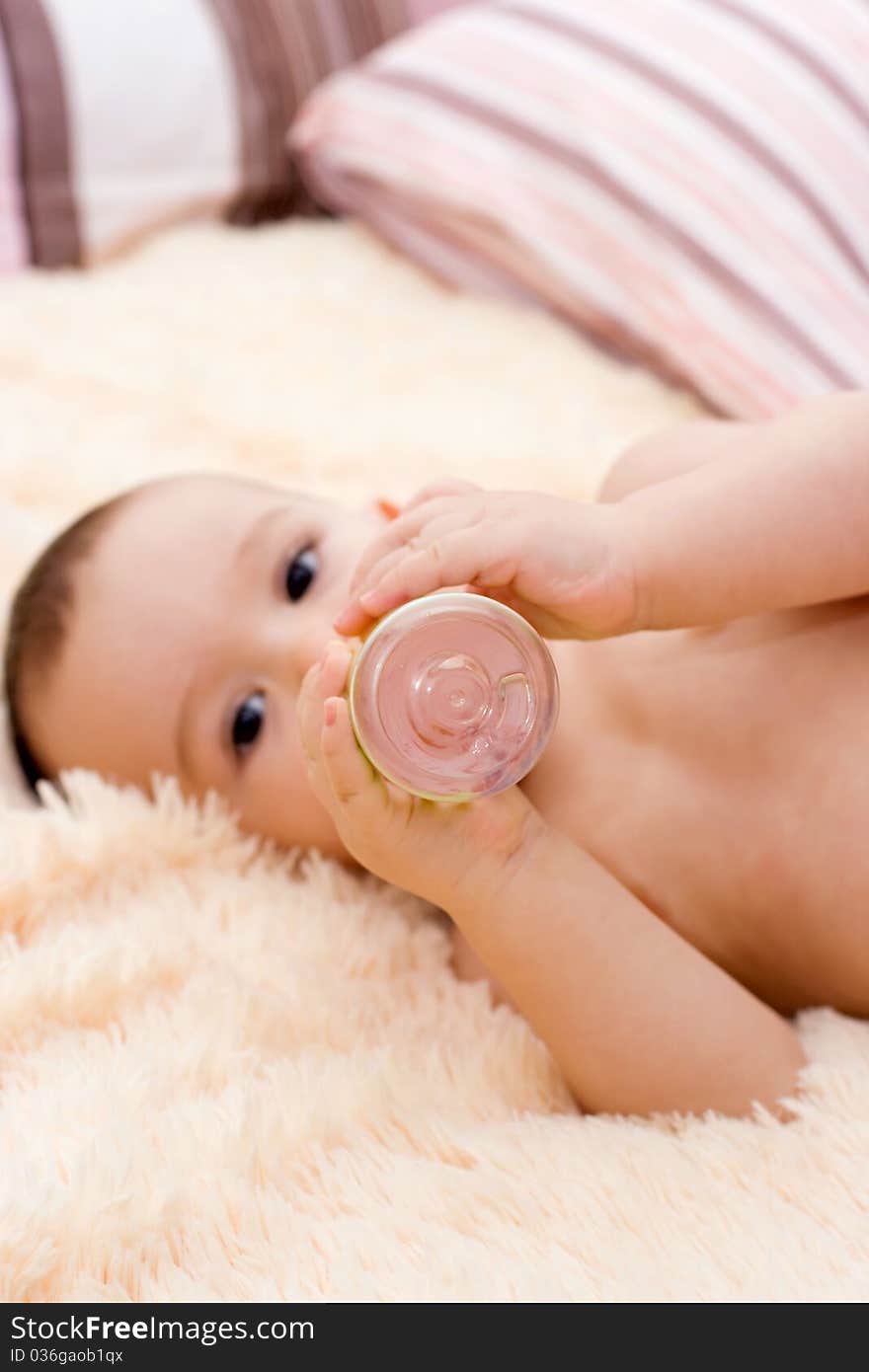 Little Caucasian Boy Drinking From The Bottle