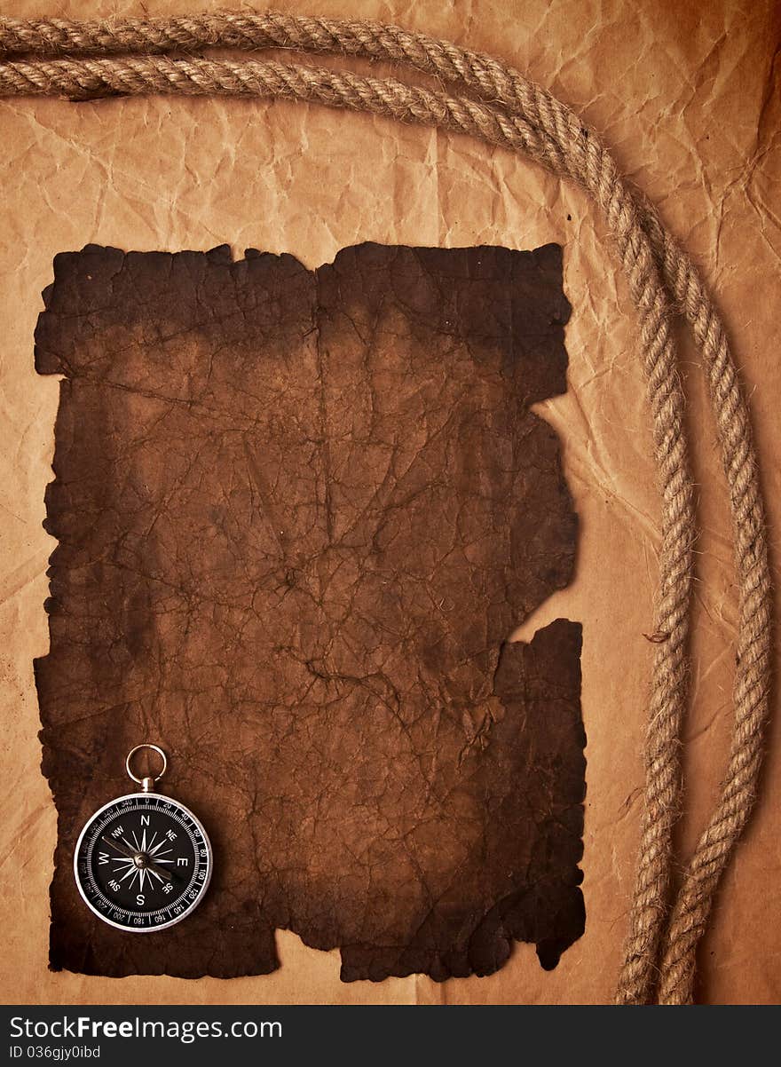 Old paper, compass and rope on grunge background