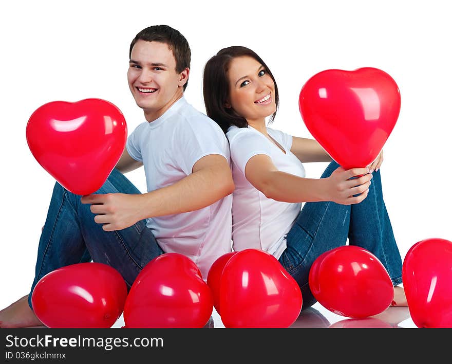 Young couple with a hearts over white background