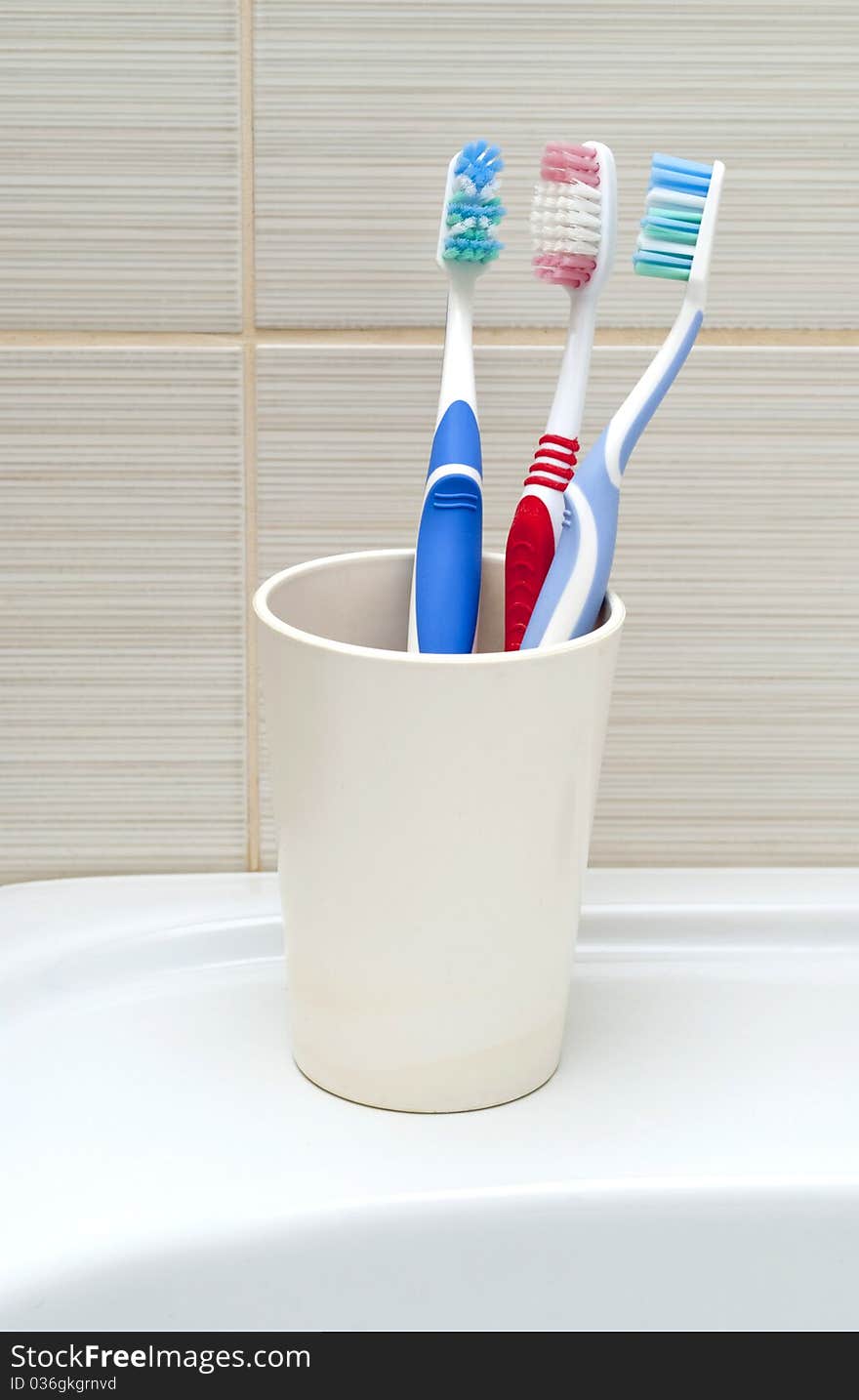 Toothbrushes in a plastic cup