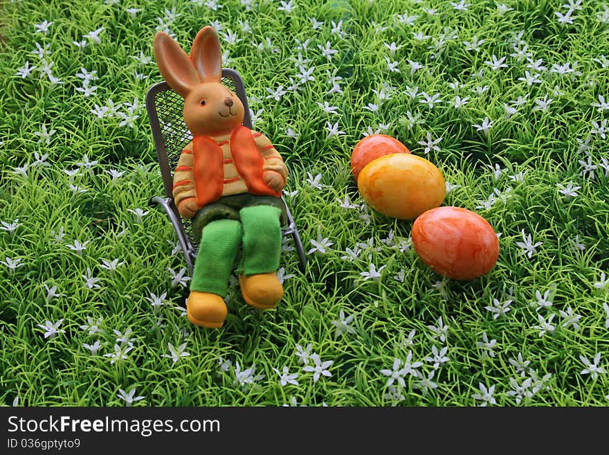 Easter eggs and an Easter bunny in the deck chair. Easter eggs and an Easter bunny in the deck chair