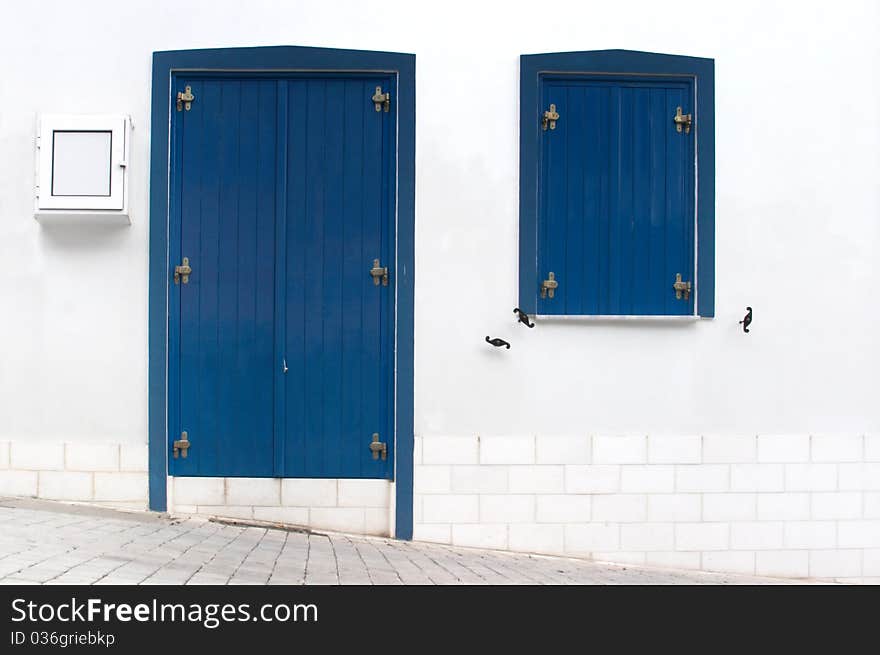 The old Greek houses with blue doors and windows. The old Greek houses with blue doors and windows