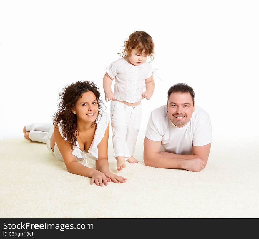 Portrait of mother, father and their child together in studio