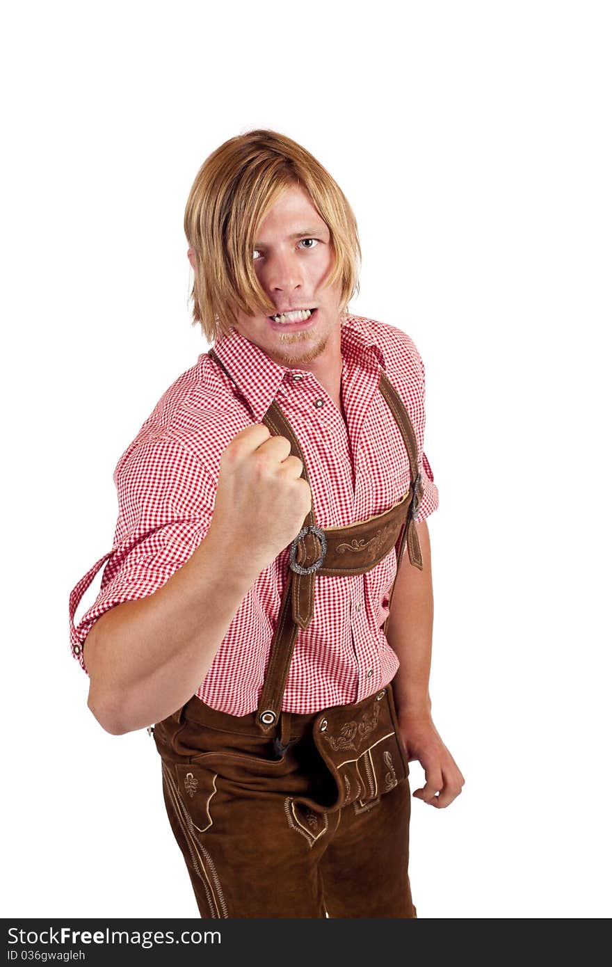 Aggressive Bavarian in leather trousers shows fist. Isolated on white background.