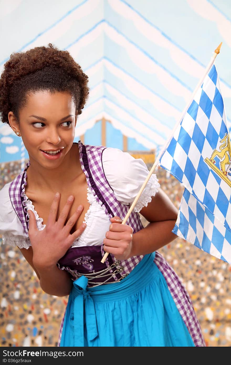 Beautiful bavarian girl with a flag