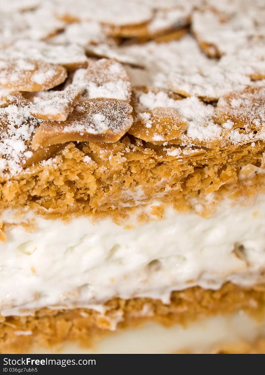 Cake almond with whipped cream and cream isolated on white close-up