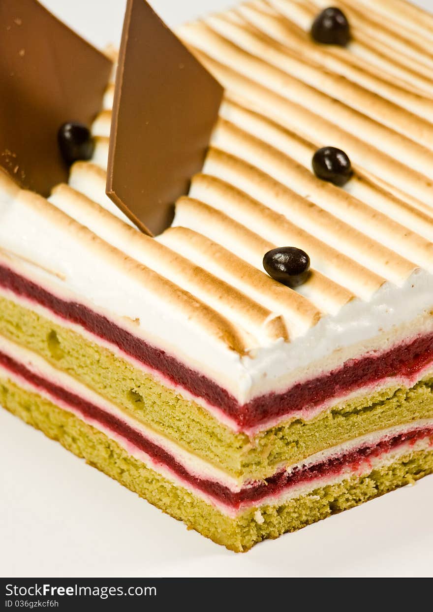 Cake pistachio, strawberries and cream close-up