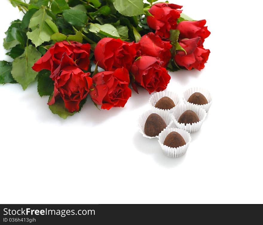 Bunch of red roses and heart-shaped gift with chocolate for St.Valentine's Day. Bunch of red roses and heart-shaped gift with chocolate for St.Valentine's Day