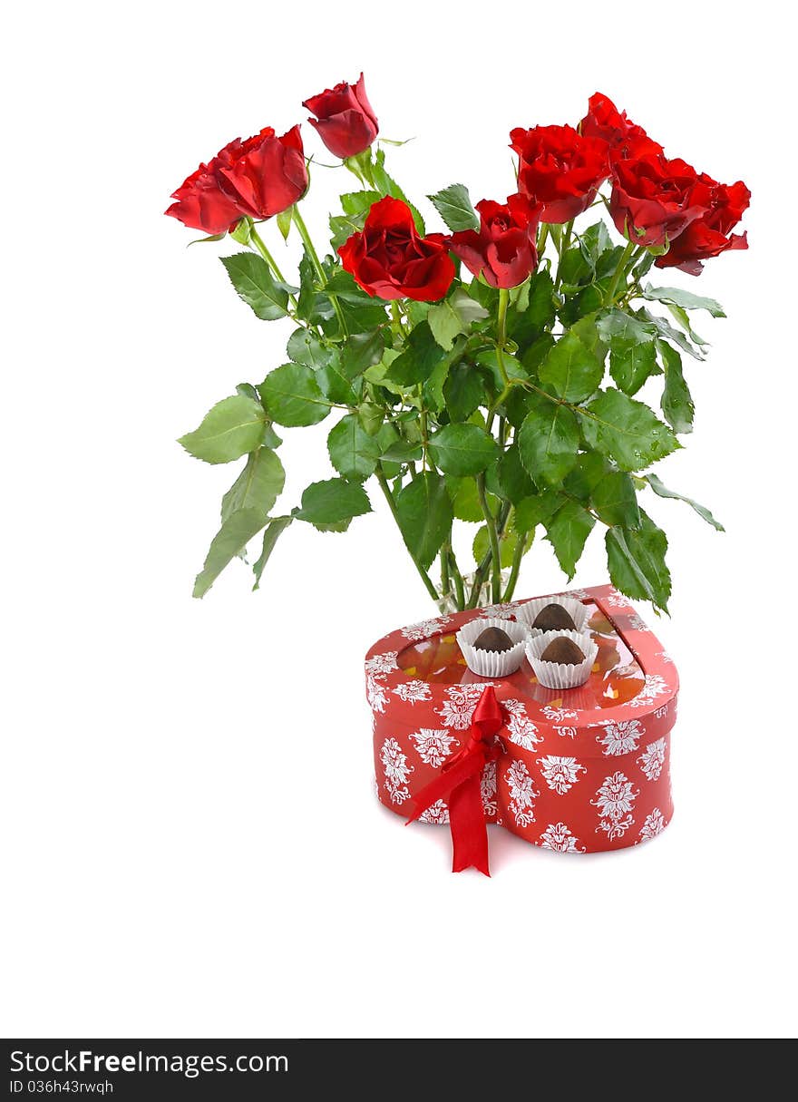 Bunch of red roses and heart-shaped gift with chocolate for St.Valentine's Day. Bunch of red roses and heart-shaped gift with chocolate for St.Valentine's Day