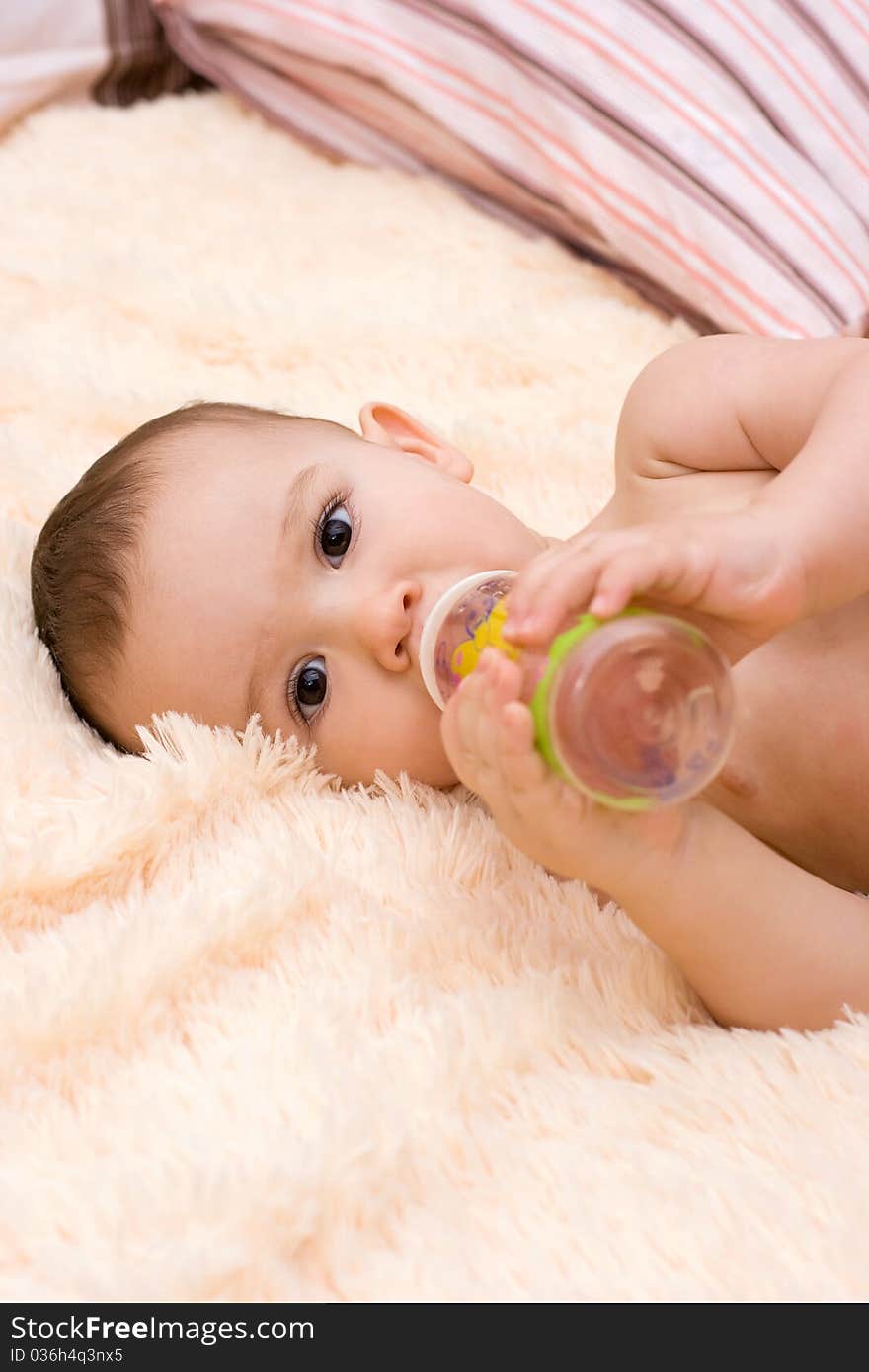 Little caucasian boy drinking juice from the bottle