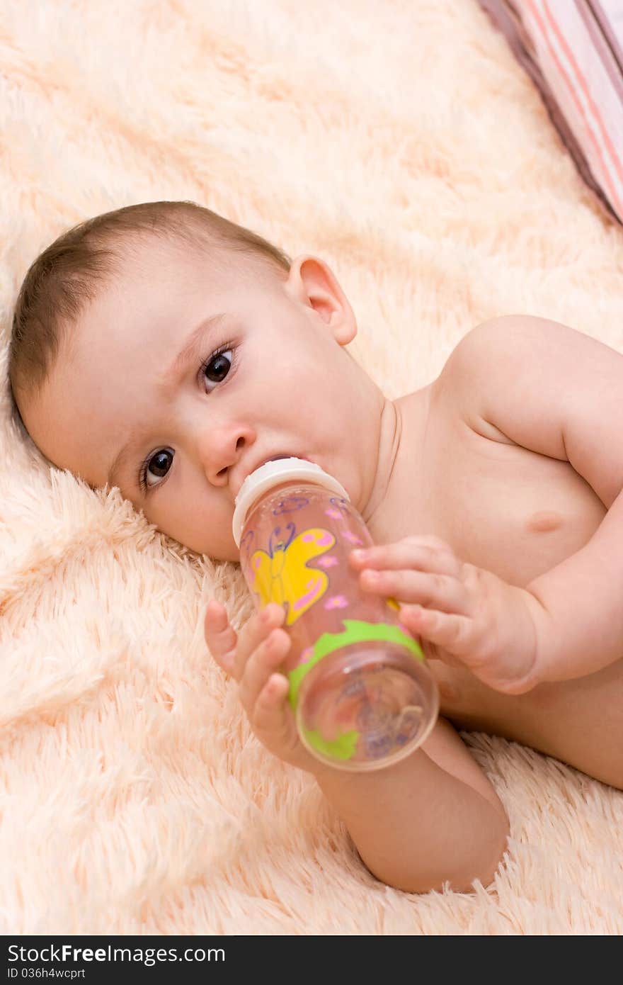 Little Caucasian Boy Drinking From The Bottle