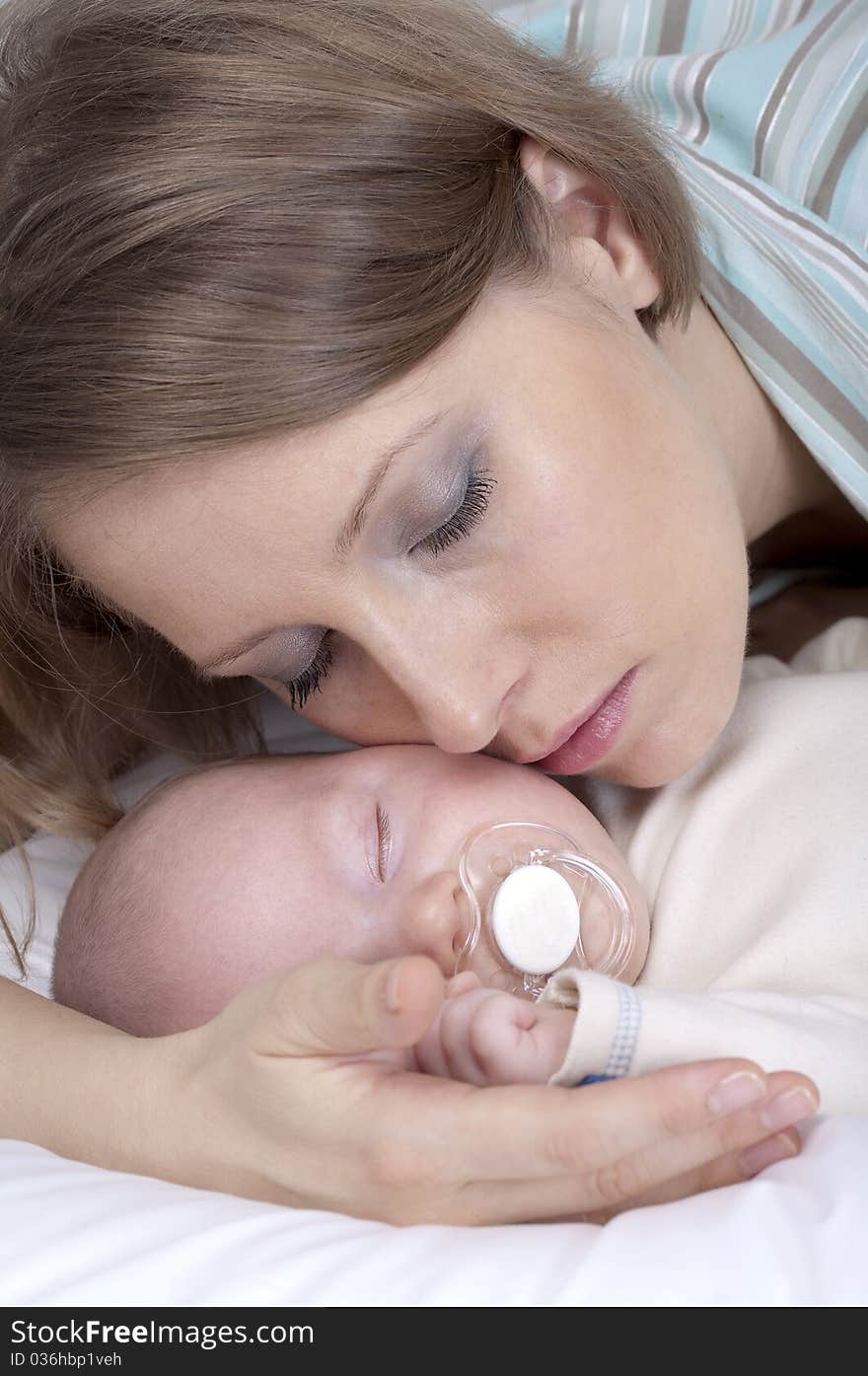 Mother kissing a little baby boy