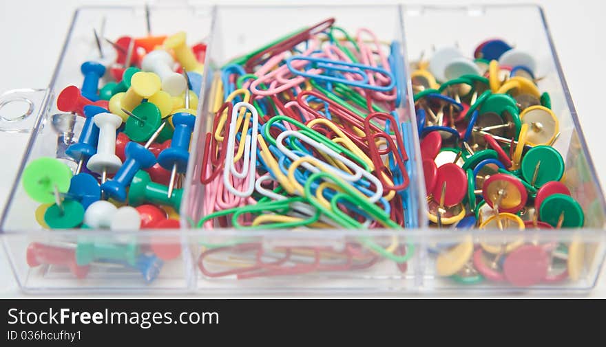 Mix of pins and paper clips in a transparent box