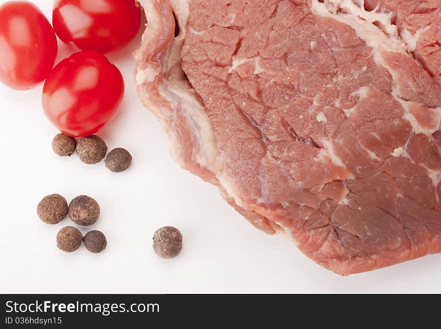 A large piece of raw meat on a white background.