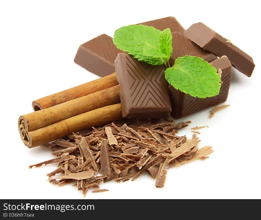 Chocolate, cinnamon with mint on a white background. Chocolate, cinnamon with mint on a white background