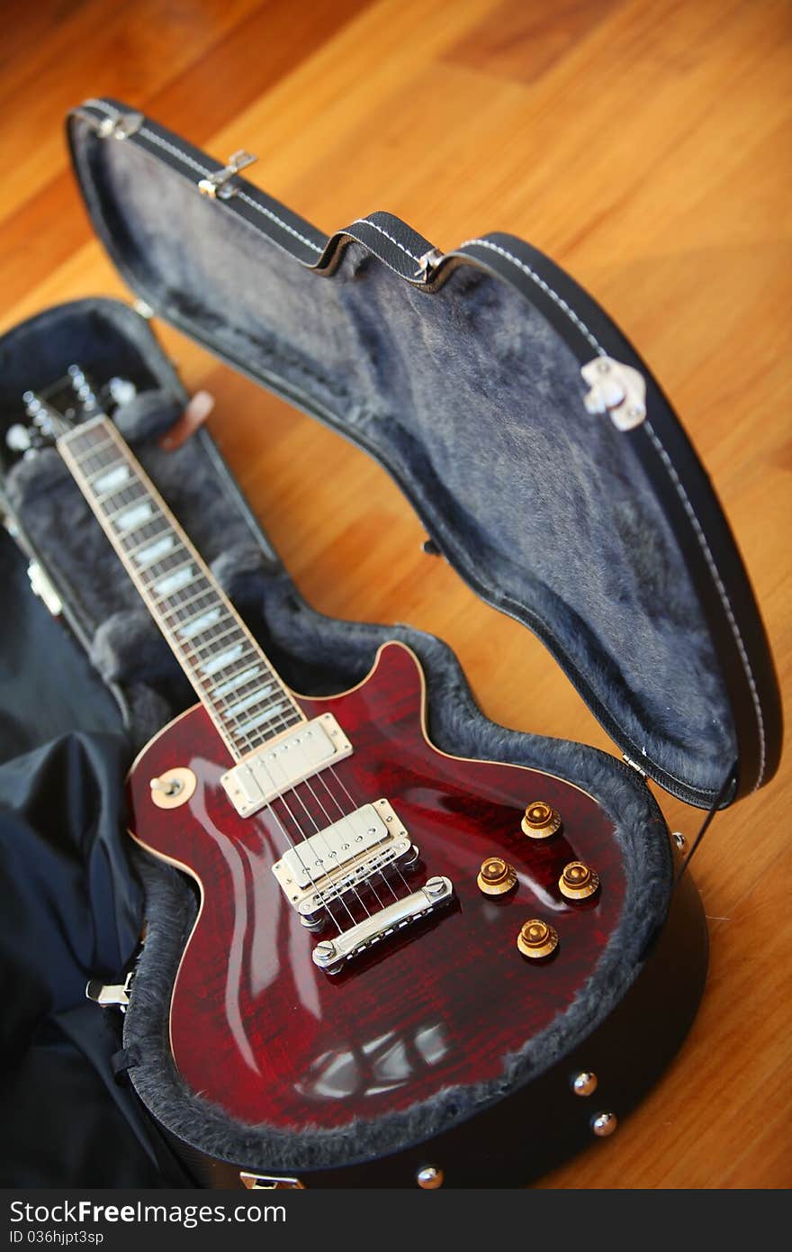 Electric guitar in the black case in the studio.