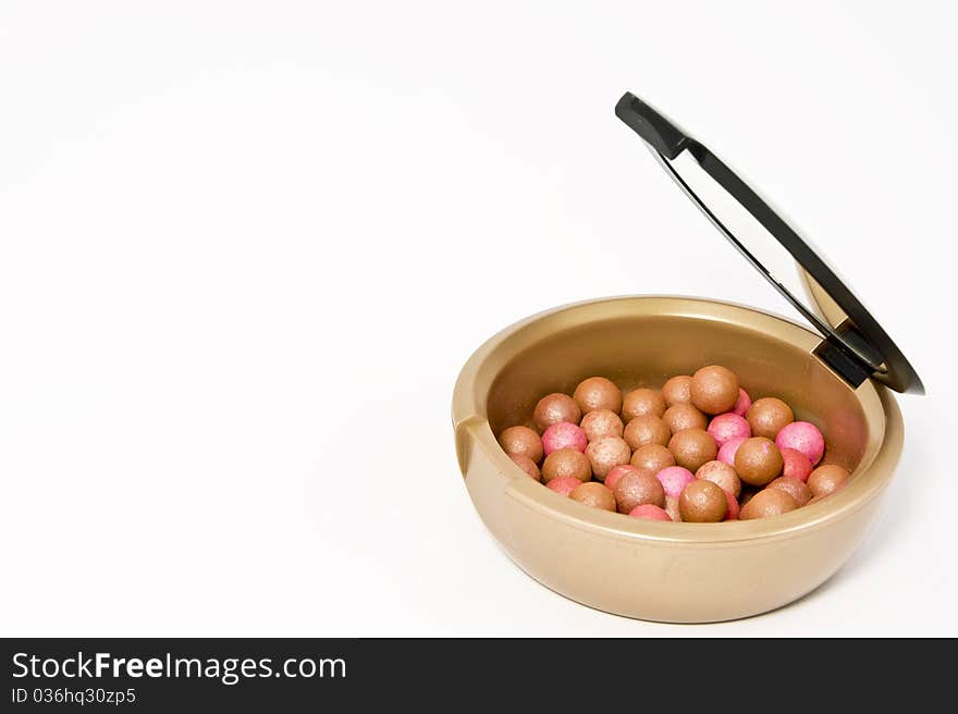 Box with bronzing pearls on white background. Box with bronzing pearls on white background