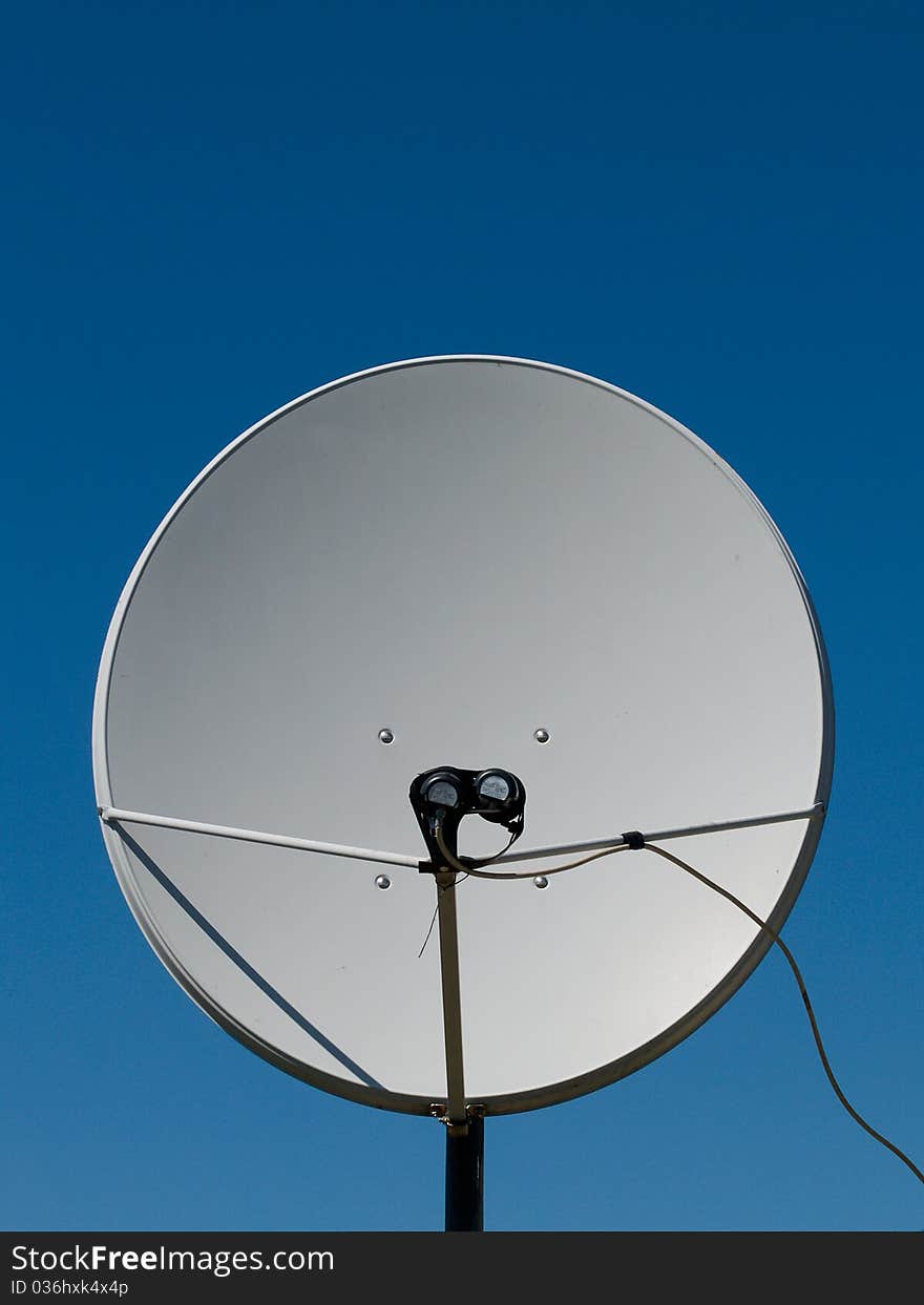 Parabolic antenna on a background of blue sky