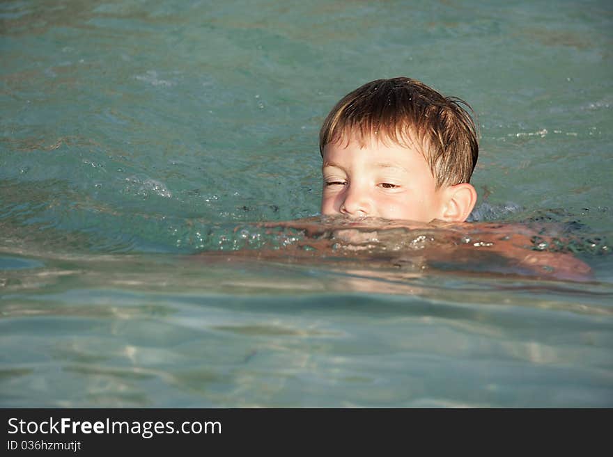 Portrait of young boy swimming