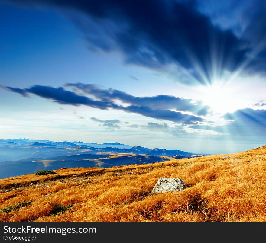 Summer landscape in mountains with the cloudy sky