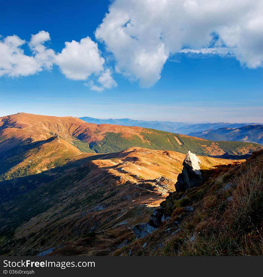 Summer landscape in mountains with the cloudy sky