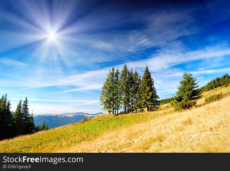 Summer landscape in mountains with the cloudy sky