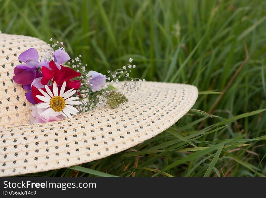 A woman hat  on a green grass