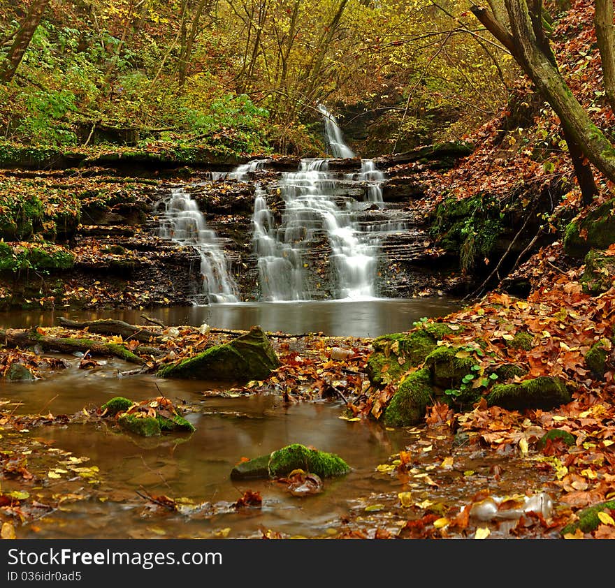 Waterfall and blue stream in the. Waterfall and blue stream in the