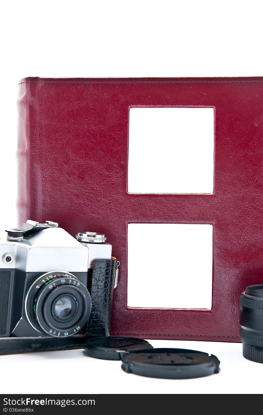 Retro camera and red photo album with empty pictures. Retro camera and red photo album with empty pictures