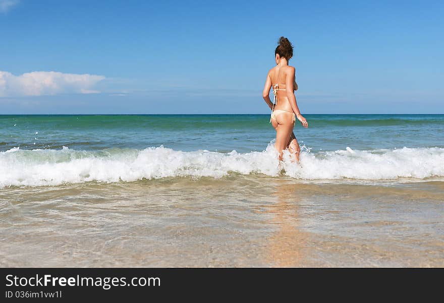 Lovely girl in sea on sunny day