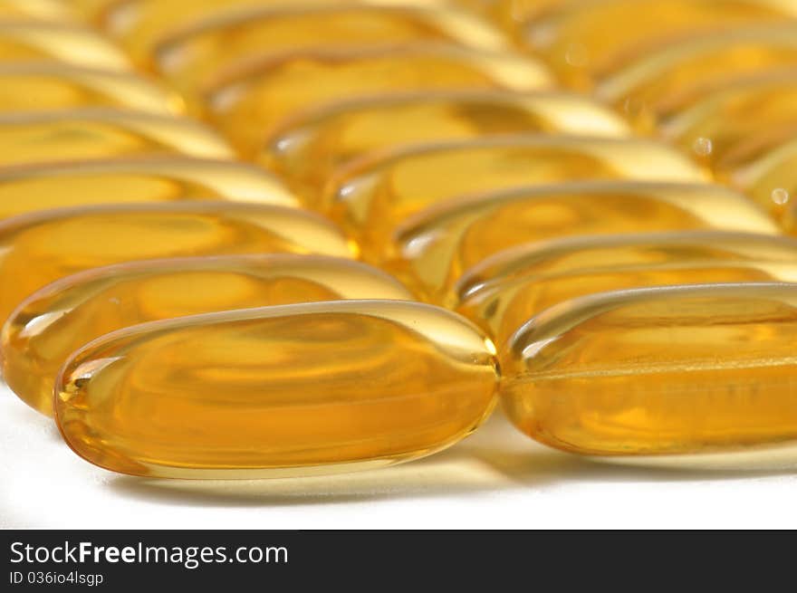 Rows of vitamin oil caplets. Rows of vitamin oil caplets