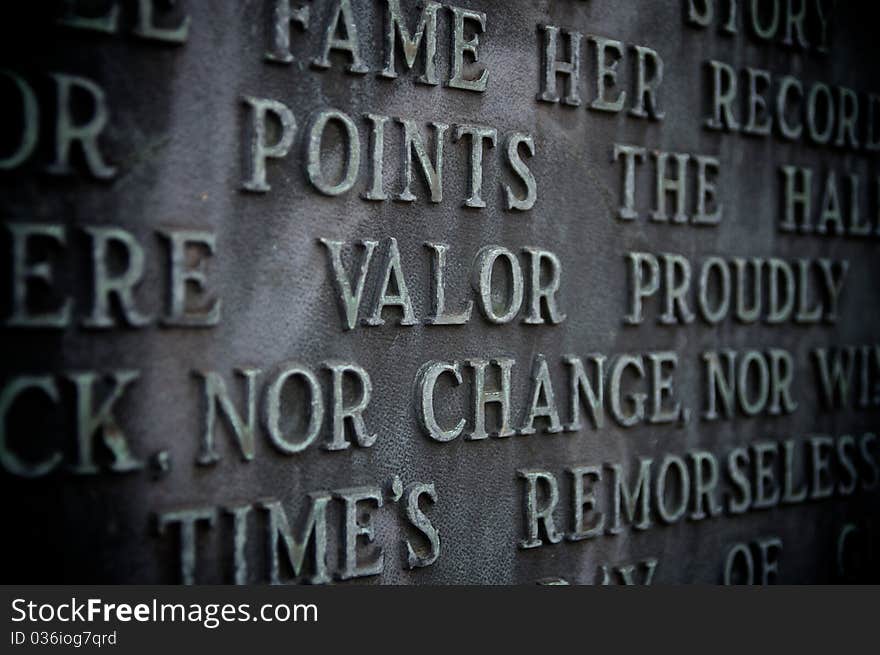 Valor spelled out on a copper monument with vignetting