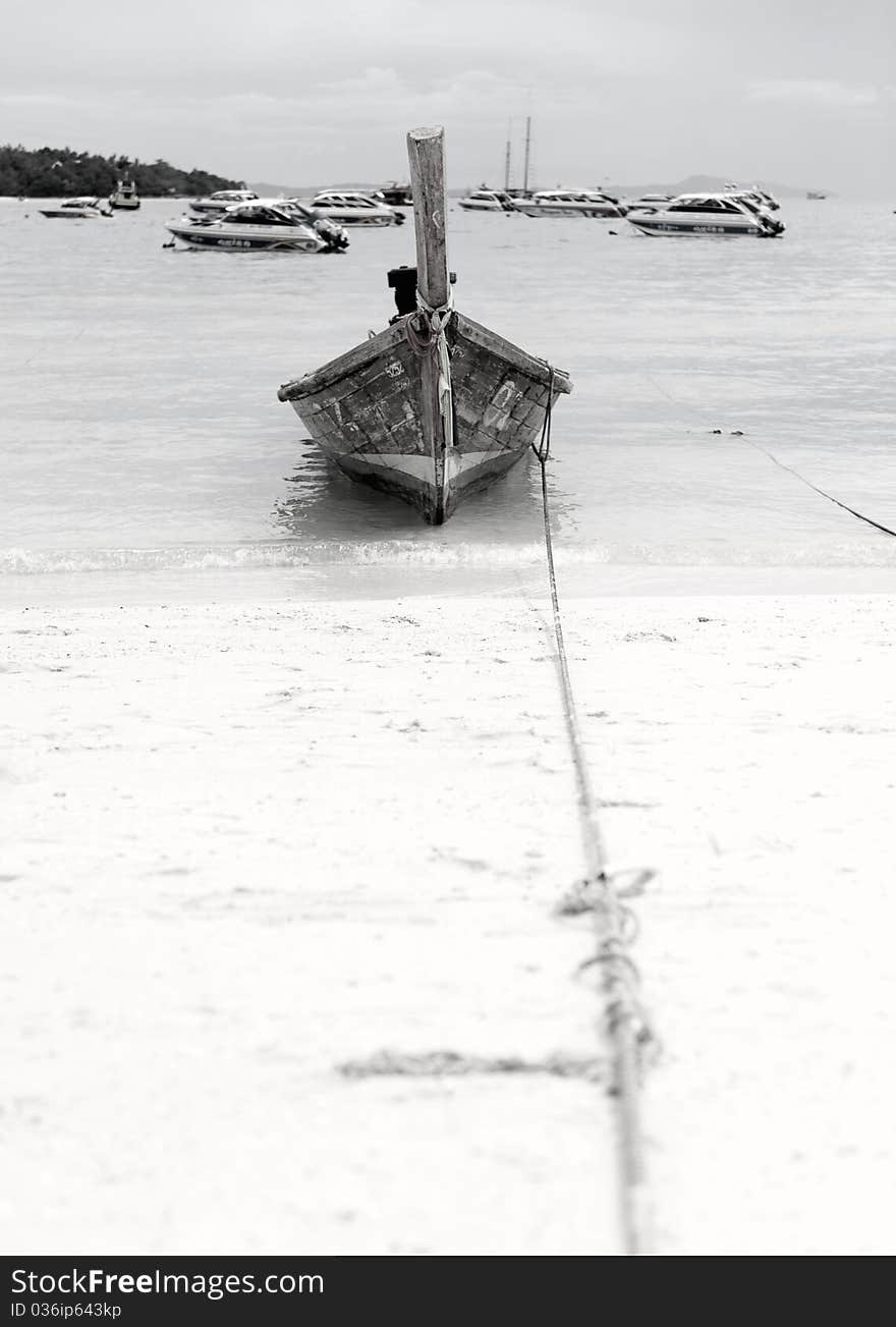 Old boat against backdrop of modern boats